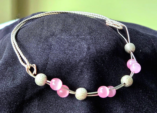 Silver twisted square wire bracelet with Pink Cat's Eye glass beads