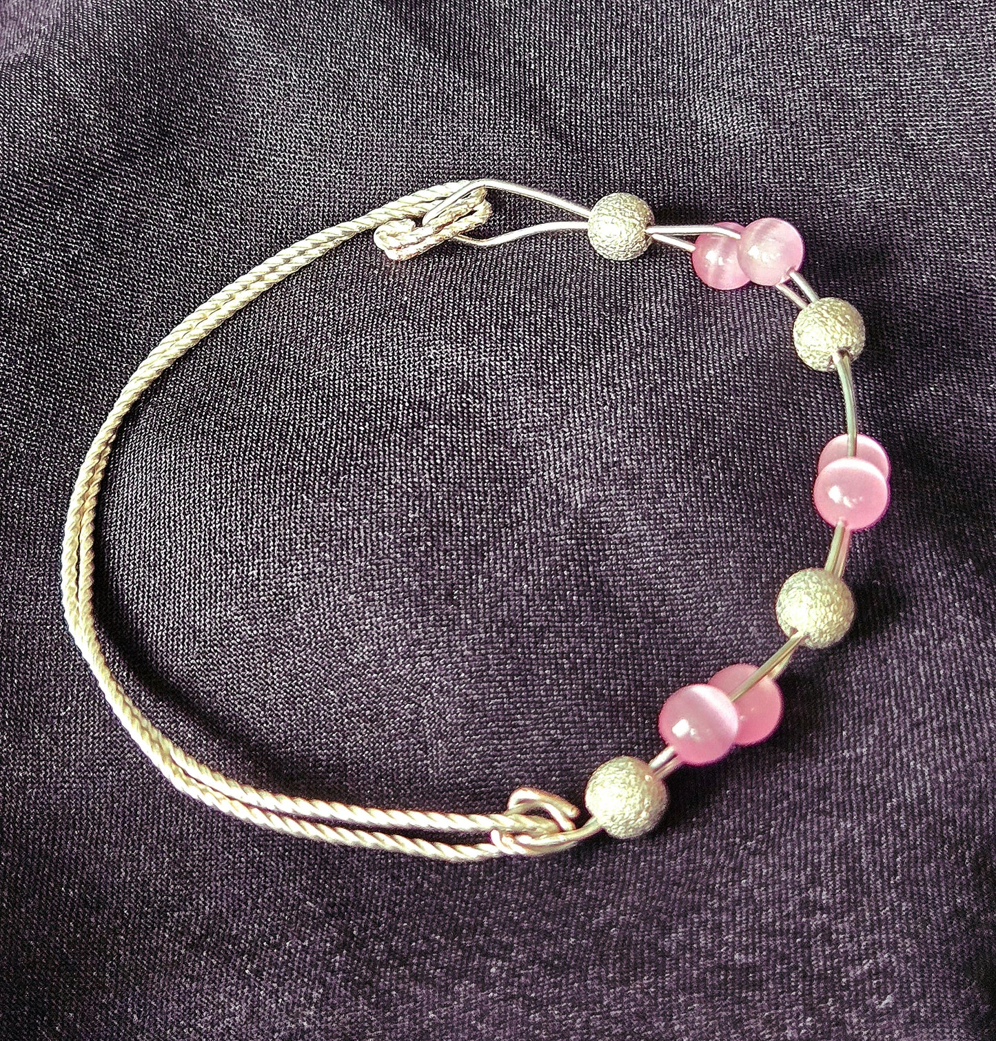 Silver twisted square wire bracelet with Pink Cat's Eye glass beads