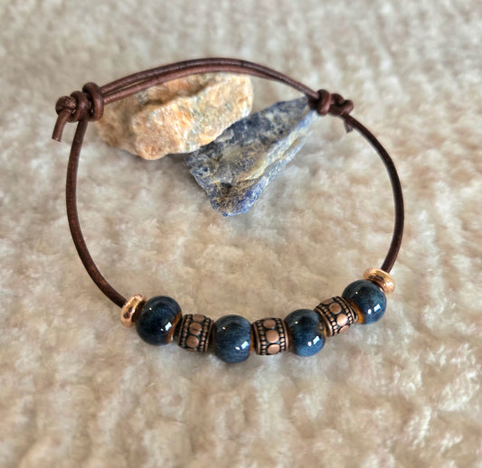 Brown leather sliding knot bracelet with blue porcelain beads