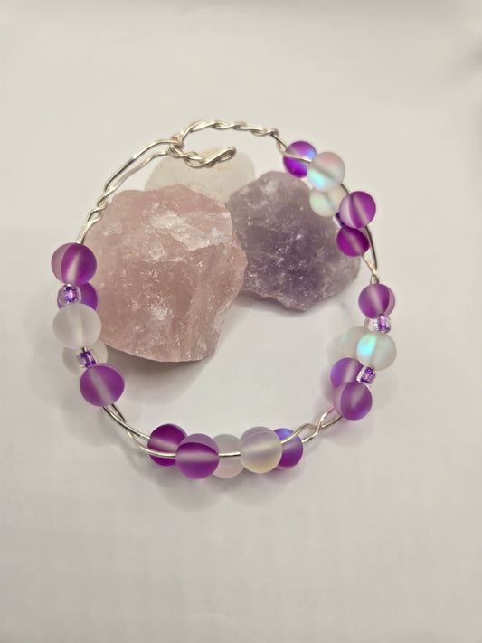Silver twisted square wire bracelet with Pink Cat's Eye glass beads