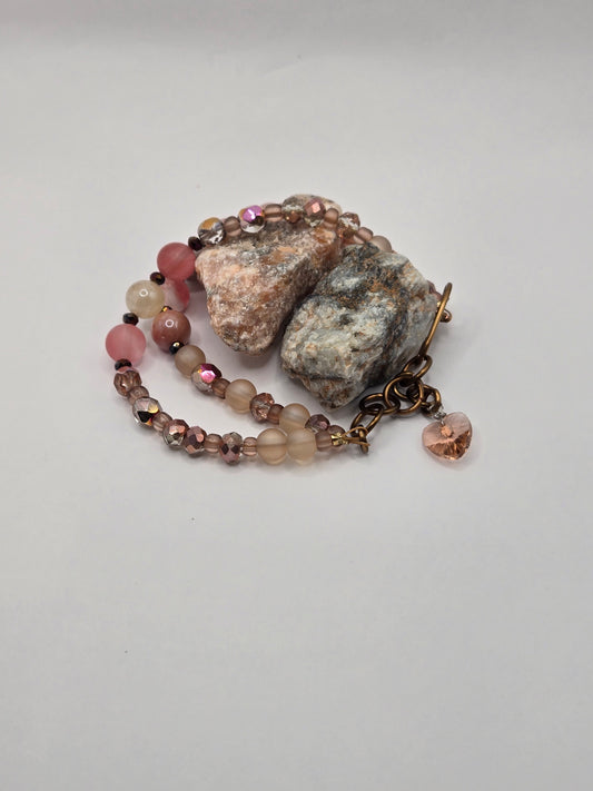 Double strand wire bracelet with glass beads and a heart glass charm